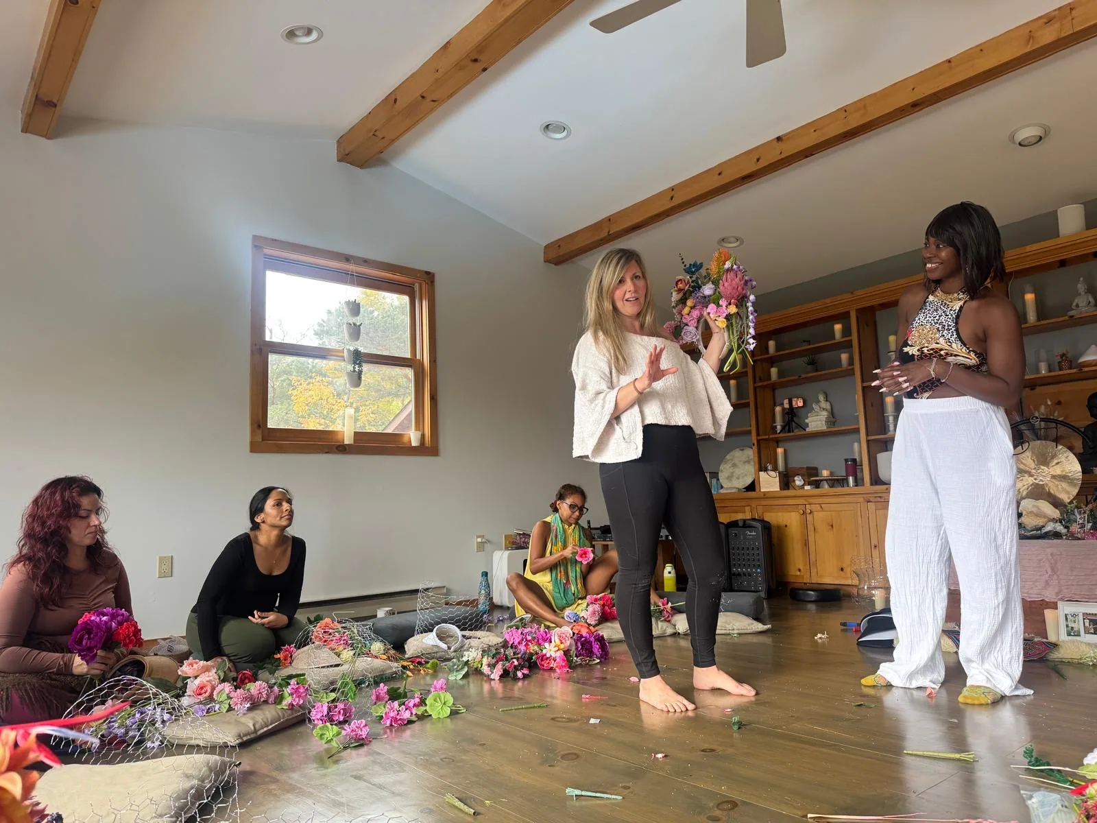 Daniela teaching a circle of women to build their flower crowns